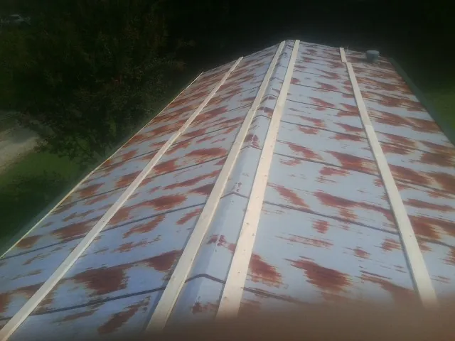 Rusted metal roof panels with new wood purlins before replacement — Storm Damage Roof Repair in Roby by Roofing Brothers